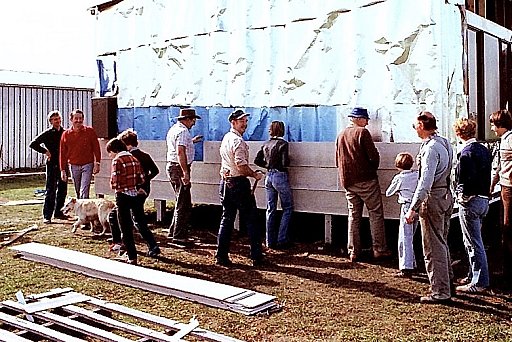 Across from the right: Dale, Peter Harris, Mel Norton, Greg Norton, ?, Darren Norton, Wally Schubach with the hammer ? ?  on the left is Gerry Mussen and the dog? - Club House Installation
